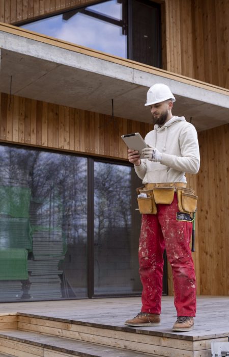 full-shot-construction-man-holding-tablet