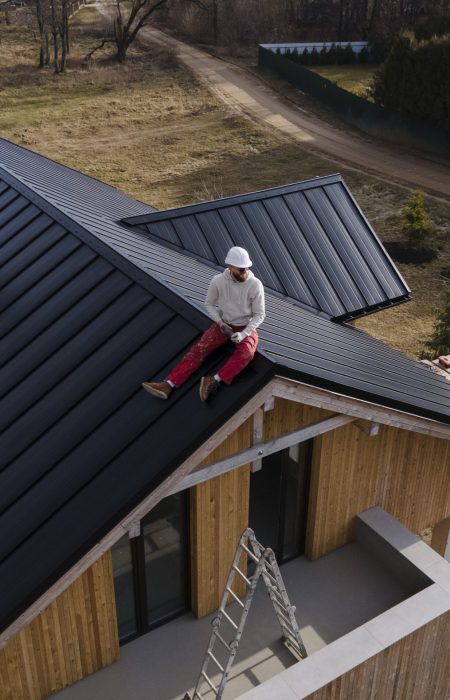 long-shot-man-with-helmet-sitting-roof